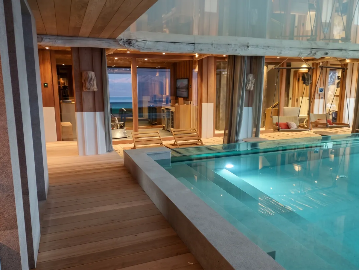 Piscine intérieure bordée d'un plancher en bois