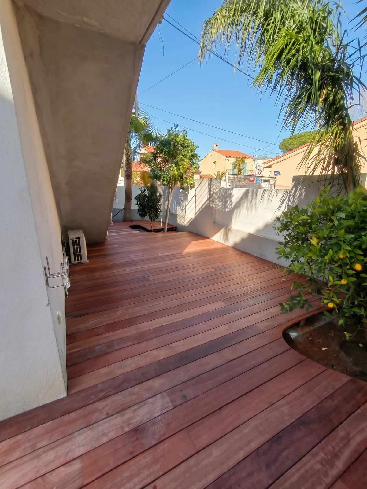 Terrasse en bois exotique le long d'une maison